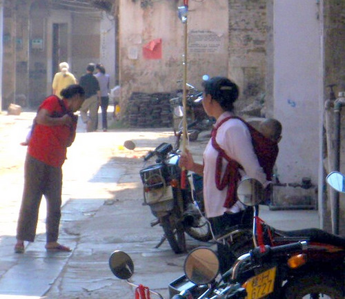 A mommy holding an IV drip stick for her child.